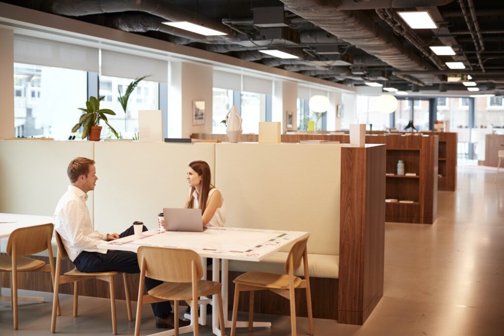 Young Businessman Having Informal Interview In Cafeteria Area At Graduate Recruitment Assessment Day